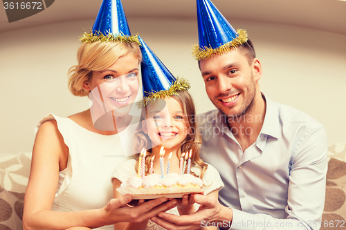 Image of smiling family in blue hats with cake