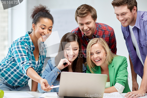 Image of group of happy high school students with laptop