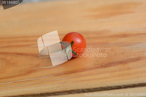 Image of red cherry tomatoes on a old wood background