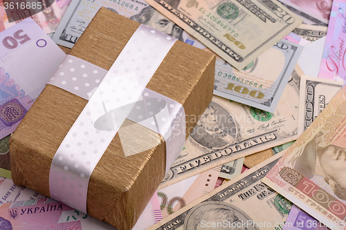 Image of american money and golden gift box, european money