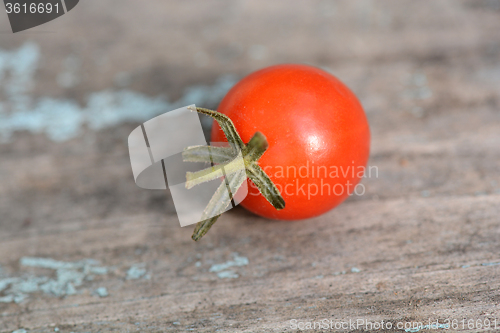 Image of red cherry tomatoes on a old wood background