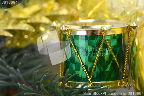 Image of Christmas background with drums, green eve tree branch, golden new year decoration 