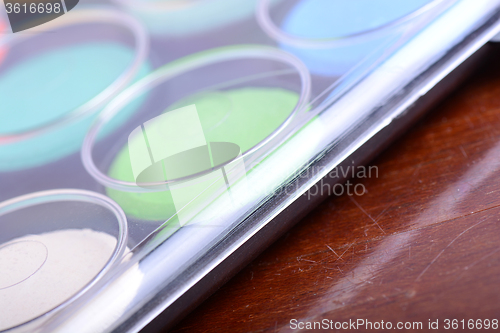 Image of Watercolor paints set on wooden background