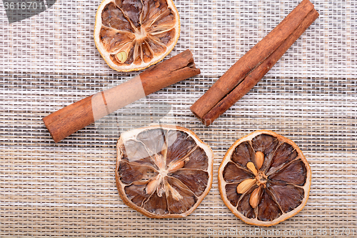 Image of Slices of fresh dried lemon, orange and spices for cooking or baking
