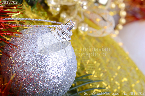 Image of Closeup of Christmas balls and green fir tree branch, new year invitation card