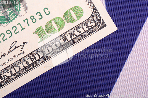 Image of American currency against an American flag backdrop.