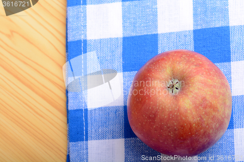Image of Red apple top view on blue material background