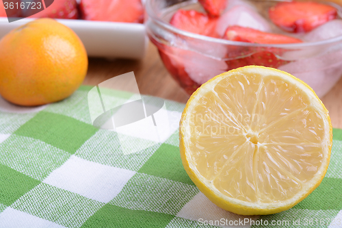 Image of Close up of a cup of sliced strawberries with lemon