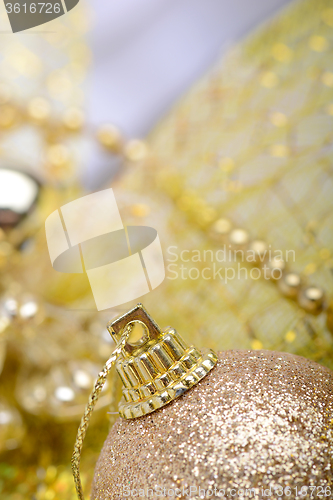 Image of festive golden christmas decoration and white balls, close up