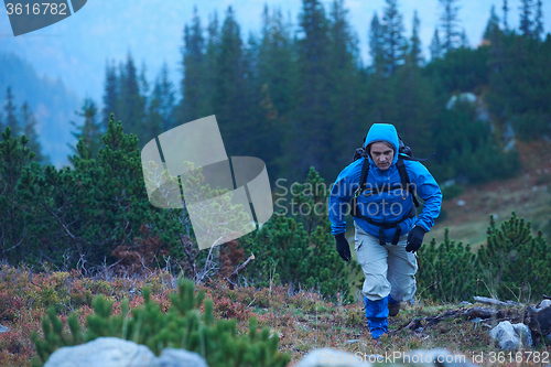 Image of advanture man with backpack hiking