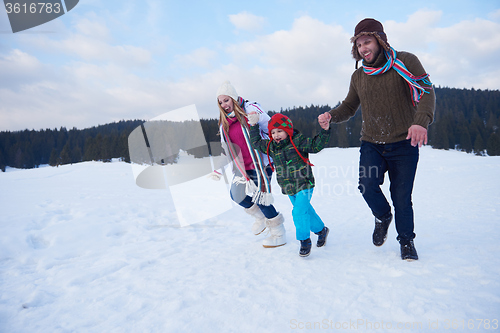 Image of happy family playing together in snow at winter