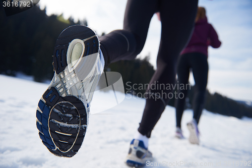 Image of couple jogging outside on snow