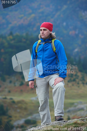 Image of advanture man with backpack hiking