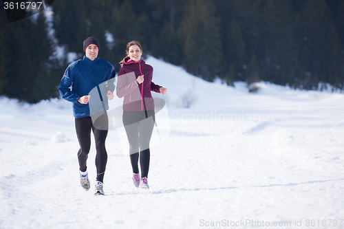 Image of couple jogging outside on snow