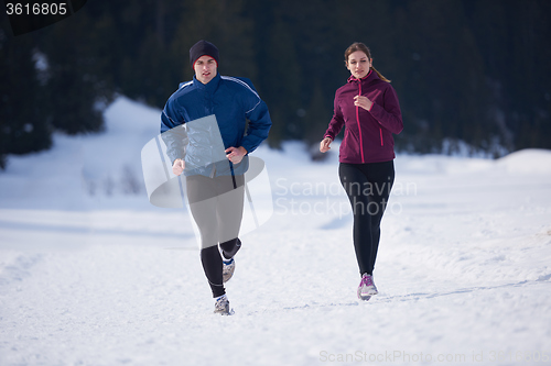 Image of couple jogging outside on snow