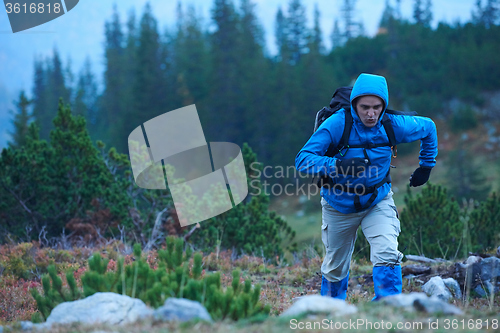 Image of advanture man with backpack hiking