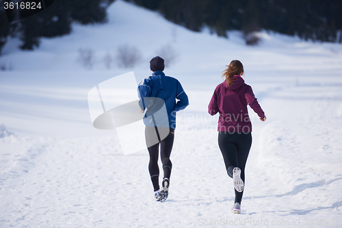 Image of couple jogging outside on snow