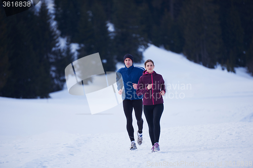 Image of couple jogging outside on snow