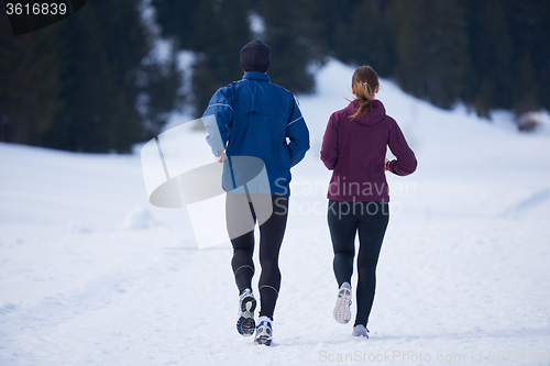 Image of couple jogging outside on snow