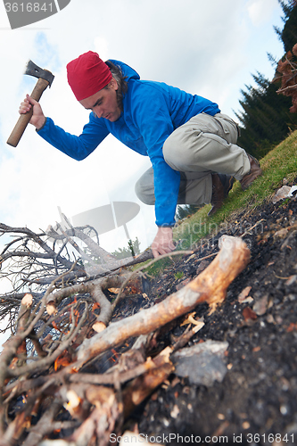 Image of hiking man try to light fire