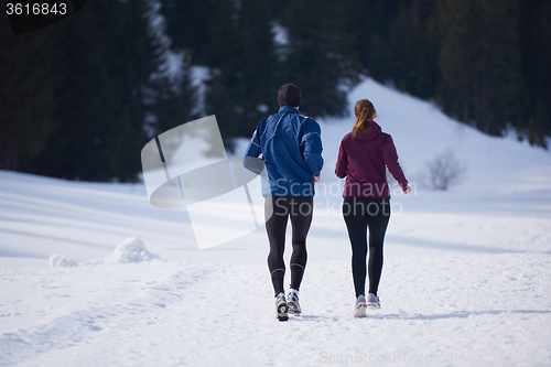 Image of couple jogging outside on snow