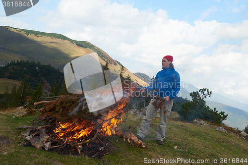 Image of hiking man try to light fire