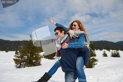 Image of happy young couple having fun on fresh show on winter vacation