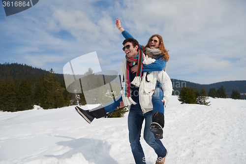 Image of happy young couple having fun on fresh show on winter vacation