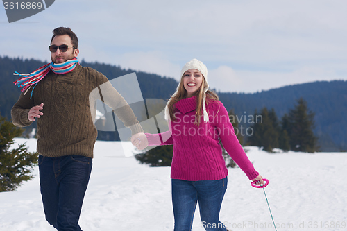 Image of happy young couple having fun on fresh show on winter vacation