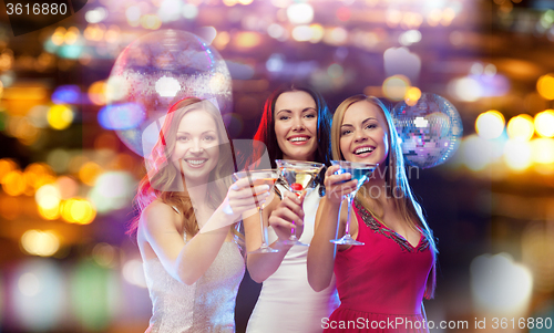 Image of smiling women with cocktails at night club