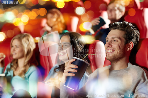 Image of happy friends watching movie in theater