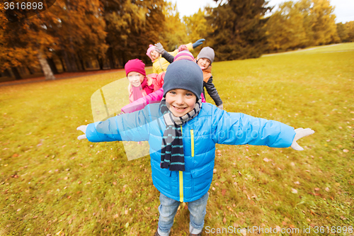 Image of happy little children playing planes outdoors