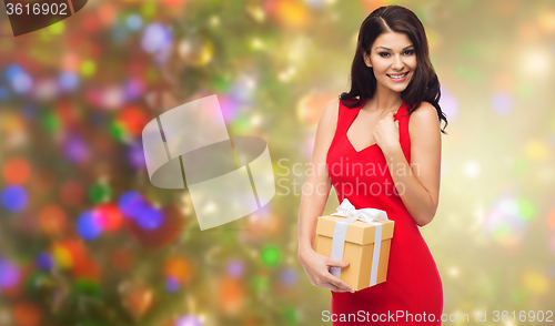 Image of beautiful sexy woman in red dress with gift box