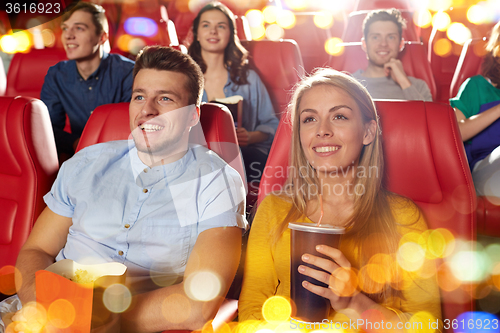 Image of happy friends watching movie in theater