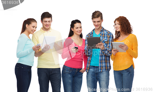 Image of group of teenagers with smartphones and tablet pc