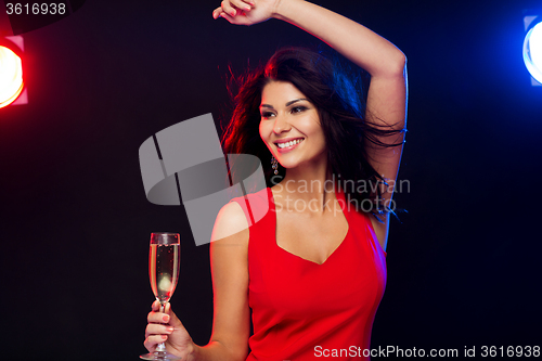 Image of beautiful woman with champagne glass at nightclub