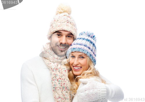 Image of smiling couple in winter clothes hugging