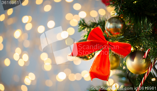 Image of close up of red bow decoration on christmas tree