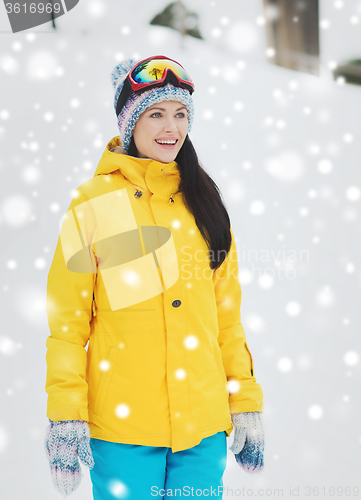 Image of happy young woman in ski goggles outdoors