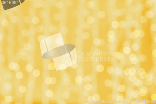 Image of blurred golden background with bokeh lights