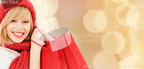 Image of smiling young woman with shopping bags