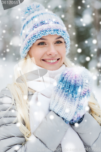 Image of smiling young woman in winter forest