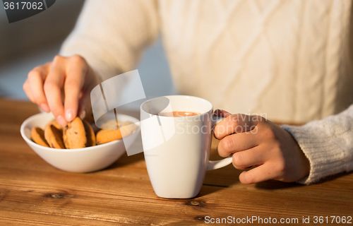 Image of close up of woman with cookies and hot chocolate