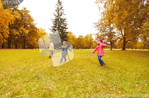 Image of happy little children running and playing outdoors