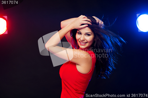 Image of beautiful sexy woman in red dancing at nightclub