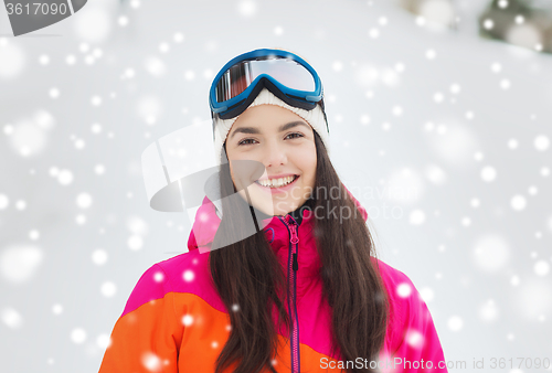 Image of happy young woman in ski goggles outdoors