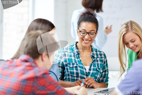 Image of group of happy high school students with workbook