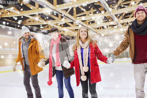 Image of happy friends on skating rink