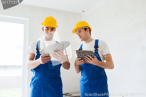 Image of builders with tablet pc and equipment indoors