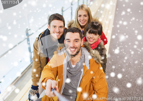 Image of happy friends taking selfie on skating rink